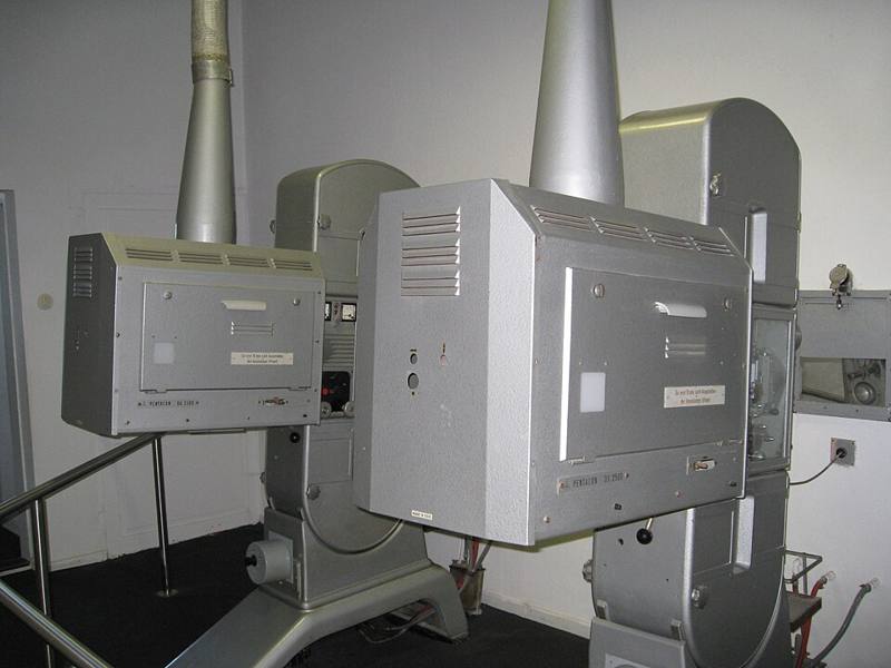 Two 35mm cinema film projectors in a projection booth